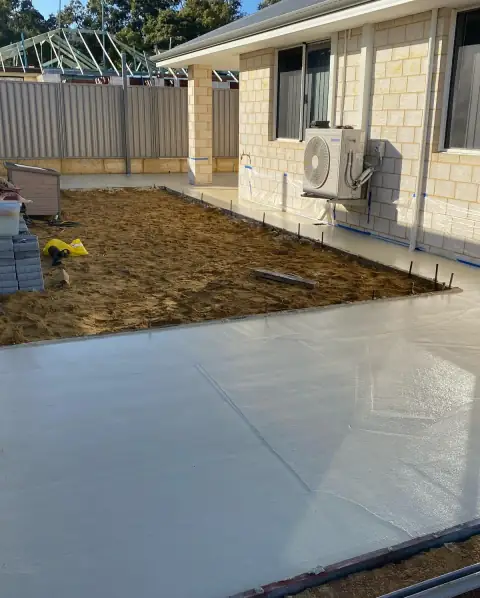 Alfresco slab just poured and still wet, with the sand prep for the next section beside it