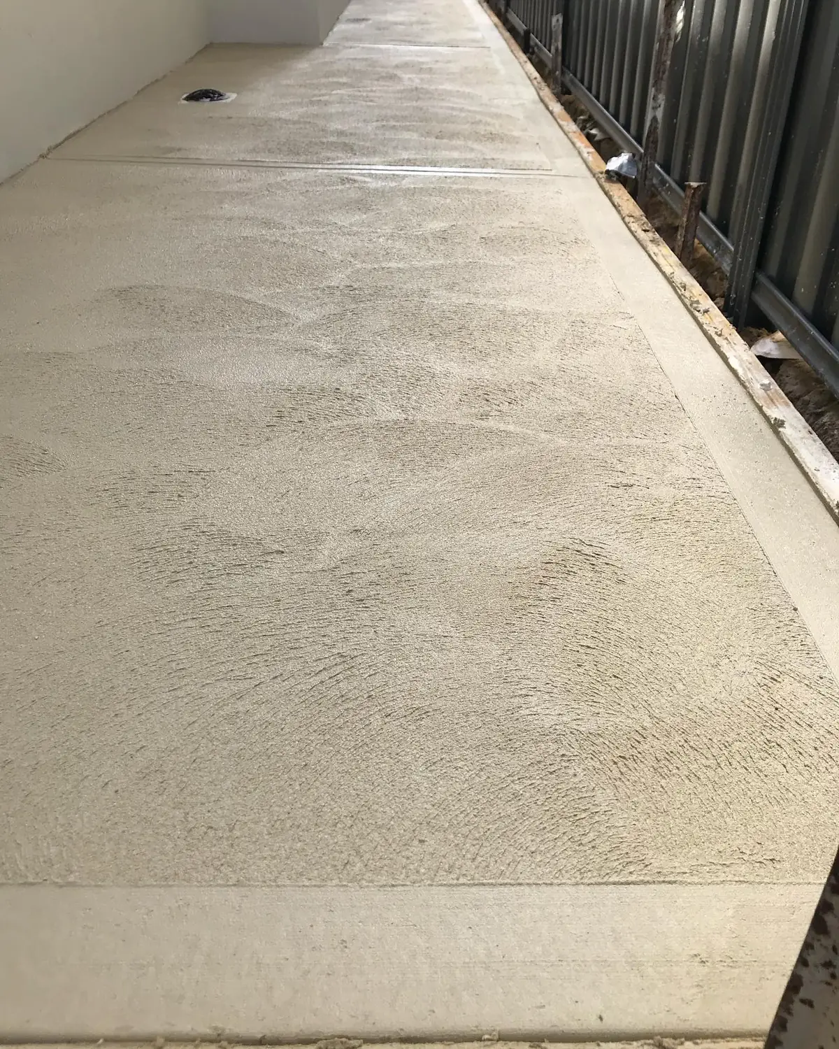 Textured liquid limestone side path with a smooth border down each side